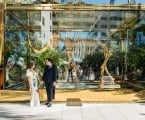 Husband and wife looking at eachother while in front of a large mammoth statue