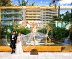 bride and groom stand in front of mammoth statue